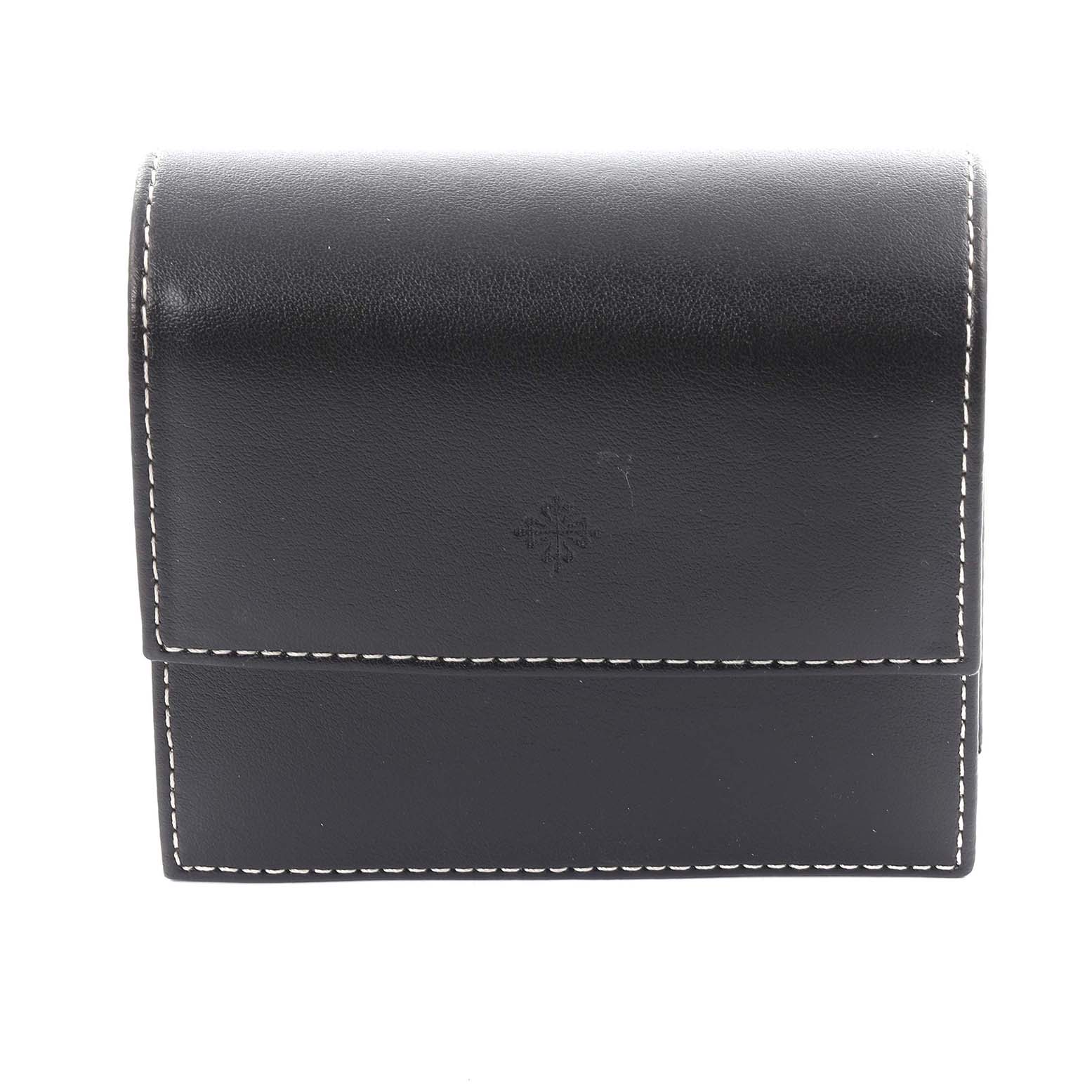 The image shows a black leather case for the Patek Philippe Twenty-4 4910/10 Women's Stainless Steel Blue Dial 4910/10 Women's Stainless Steel Blue Dial, viewed from the front with white stitching detail.