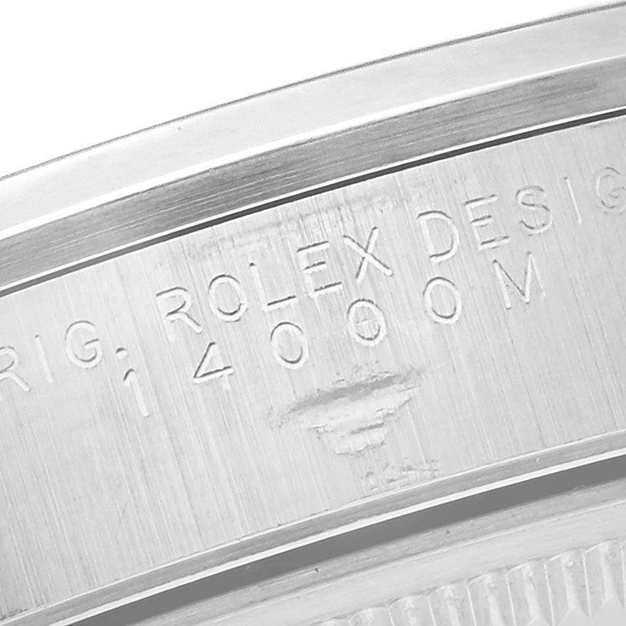 The image shows an angled close-up of the Rolex Air-King 14000 Men's Stainless Steel Black Dial 14000 Men's Stainless Steel Black Dial's case back, highlighting engraved text.