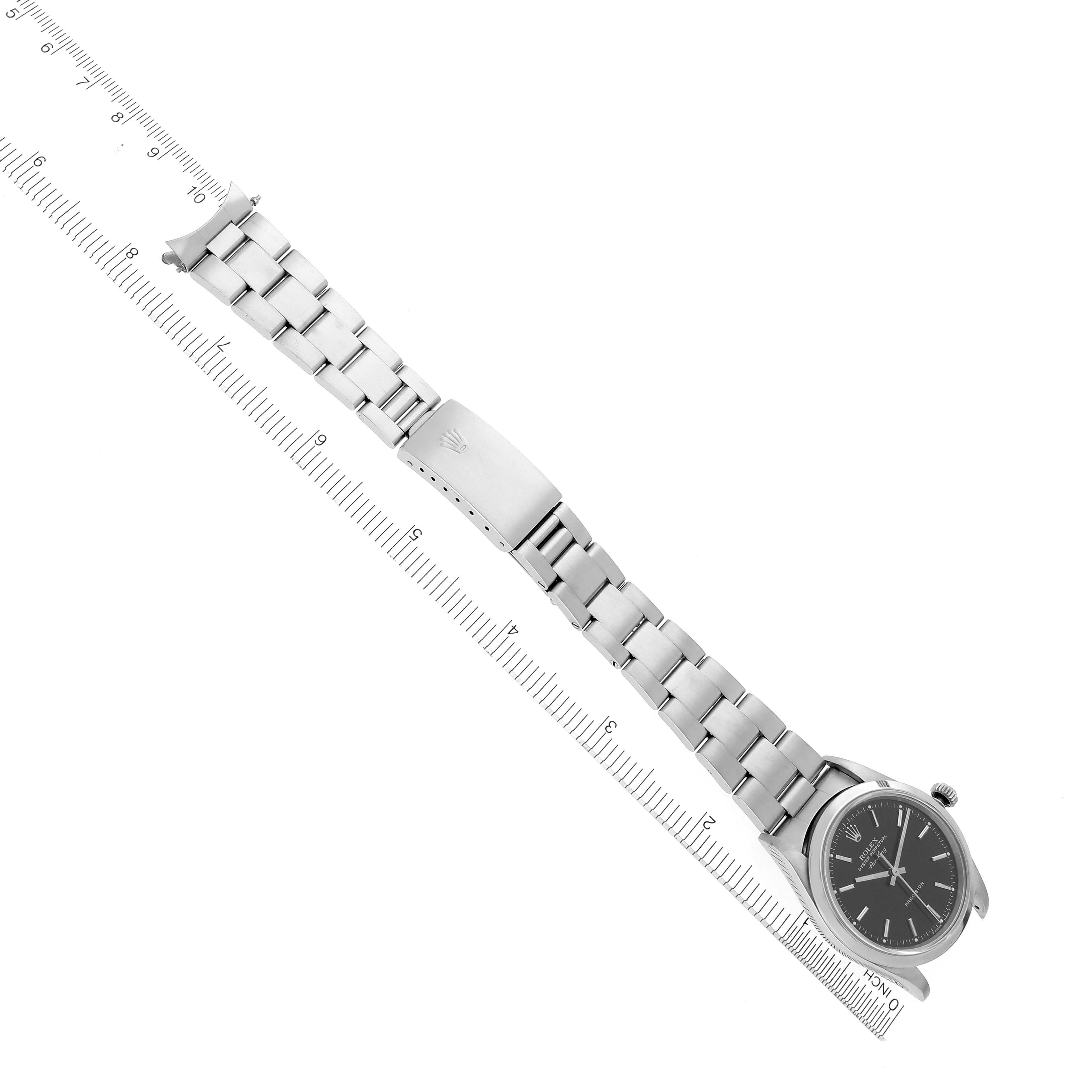 The Rolex Air-King 14000 Men's Stainless Steel Black Dial 14000 Men's Stainless Steel Black Dial watch is shown from above, displaying the face, bracelet, and clasp, aligned with a ruler.