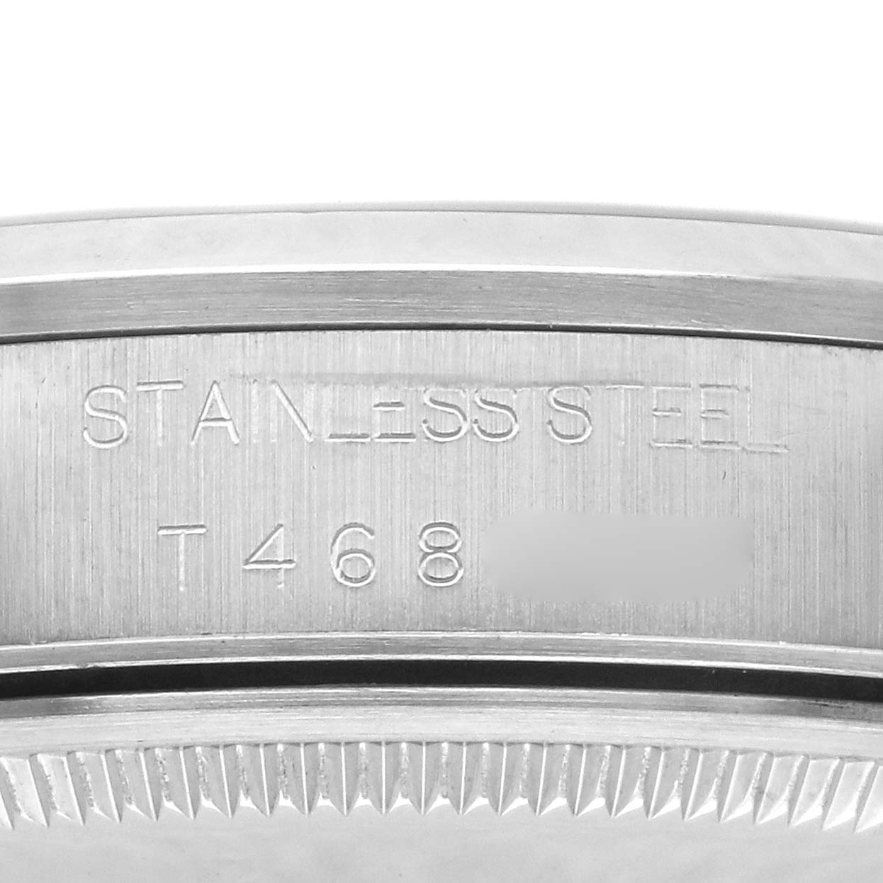 The image shows a close-up of the stainless steel case back edge of a Rolex Air-King 14000 Men's Stainless Steel Black Dial 14000 Men's Stainless Steel Black Dial watch, featuring engraved text.