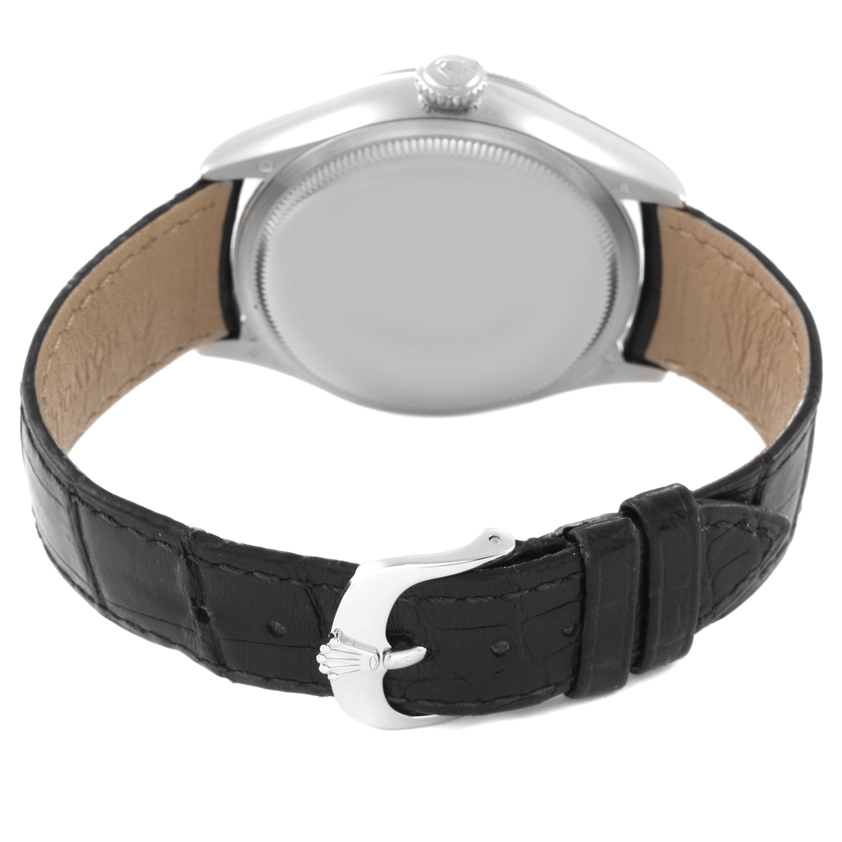 The Rolex Cellini 50529 Men's White Gold Black Dial watch is shown from the back, featuring the case back and black leather strap with a metal buckle.