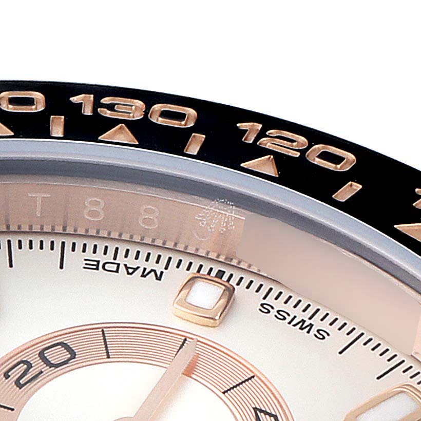 Close-up of the Rolex Daytona 116515LN Men's Rose Gold Silver Dial 116515LN Men's Rose Gold Silver Dial watch showing part of the bezel, dial, and hands.