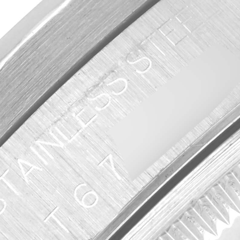 The image shows a close-up of the edge of a Rolex Date 15210 Men
s Stainless Steel Black Dial 15210 Men
s Stainless Steel Black Dial model, highlighting the stainless steel part.