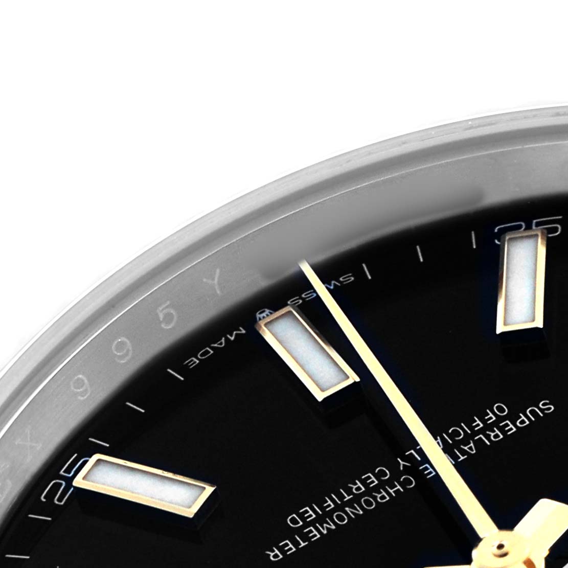 The image shows a close-up of the dial's upper section of a Rolex Datejust 41 126333 Men's Steel and Gold (two tone) Black Dial, highlighting the hour markers and part of the hands.