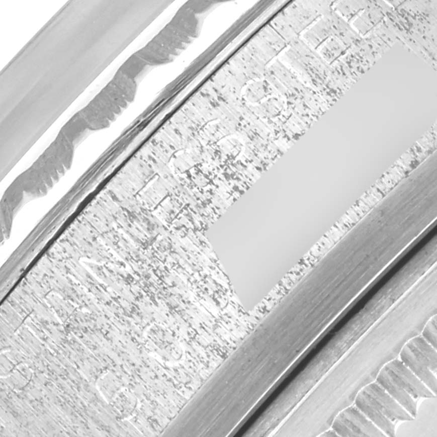 The image shows a close-up of the side engraving on a Rolex Vintage Collection 1603 Men's Stainless Steel Champagne Dial 1603 Men's Stainless Steel Champagne Dial watch bezel.