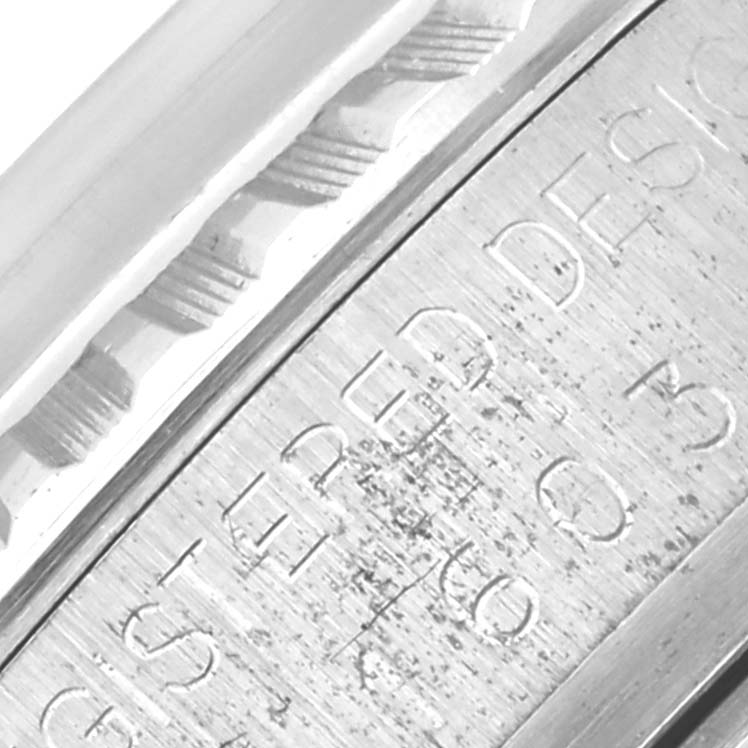 The image shows an engraved side view of the Rolex Vintage Collection 1603 Men's Stainless Steel Champagne Dial 1603 Men's Stainless Steel Champagne Dial watch, focusing on its bezel and engraved details.