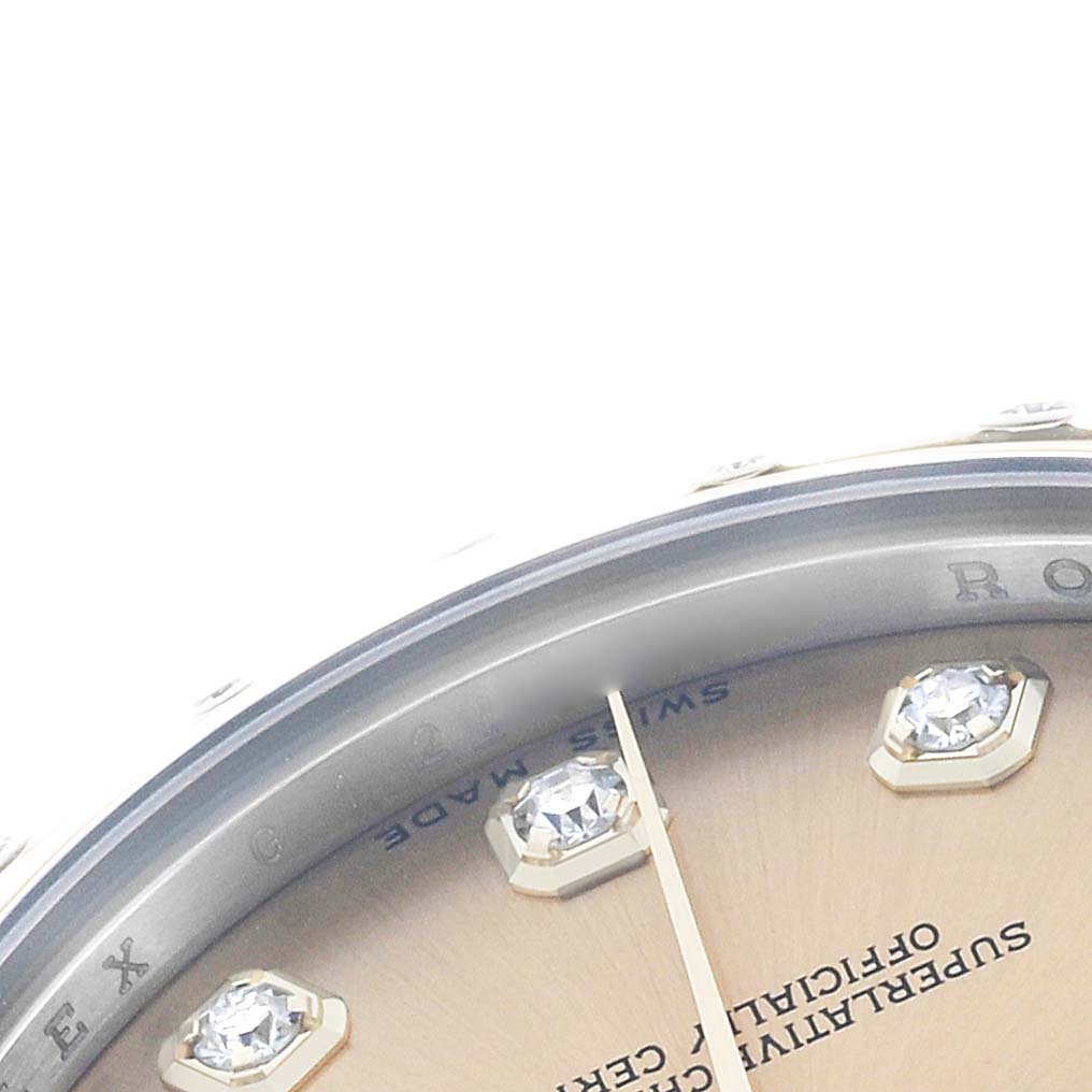 The image shows a close-up of the Rolex Mid-Size 178343 Women's Steel and Gold (two tone) Champagne Dial watch face, highlighting the bezel, dial, and diamond markers.