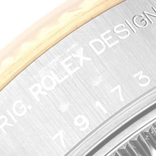 This close-up shows the engraved side of the case of a Rolex Datejust 79173 Women's Steel and Gold (two tone) Mother of Pearl Dial 79173 Women's Steel and Gold (two tone) Mother of Pearl Dial watch.
