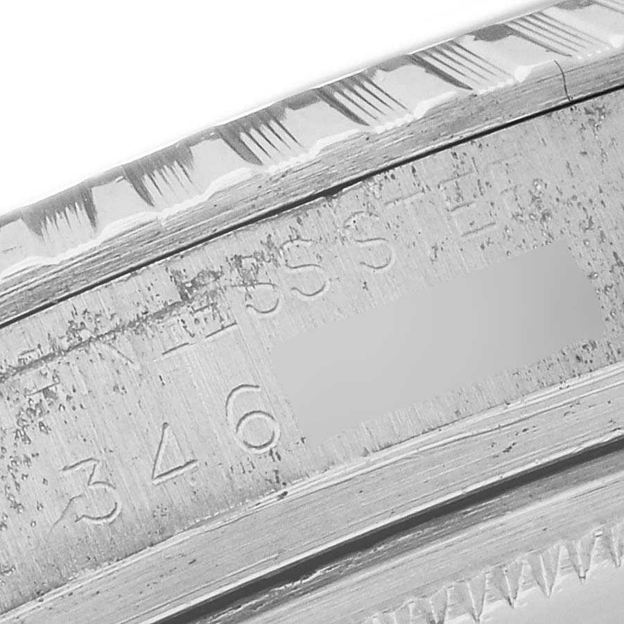 The image shows a close-up of the engraved case edge of the Rolex Vintage Collection 1603 Men's Stainless Steel Silver Dial 1603 Men's Stainless Steel Silver Dial model.