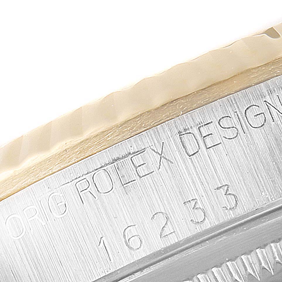 The image shows a close-up of the bezel and engraved text on the case side of a Rolex Datejust 16233 Men's Steel and Gold (two tone) Champagne Dial 16233 Men's Steel and Gold (two tone) Champagne Dial watch.