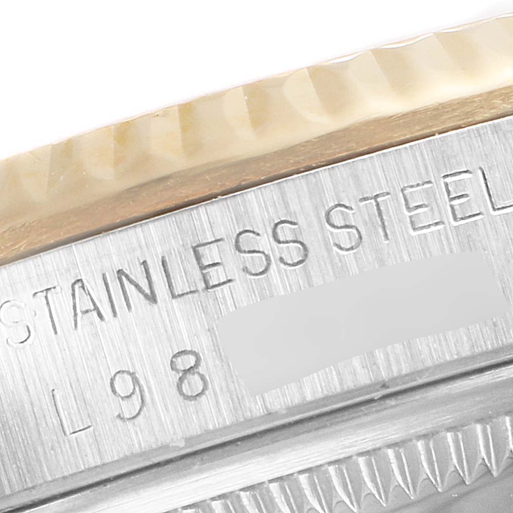 This close-up image of the Rolex Datejust 16233 Men's Steel and Gold (two tone) Champagne Dial 16233 Men's Steel and Gold (two tone) Champagne Dial watch shows the stainless steel case with engraved text.