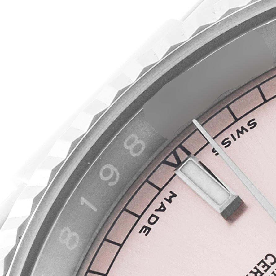 The image shows a close-up of a Rolex Datejust 116234 Men's Stainless Steel Pink Dial 116234 Men's Stainless Steel Pink Dial watch face, including the bezel, partial dial, and hour marker.