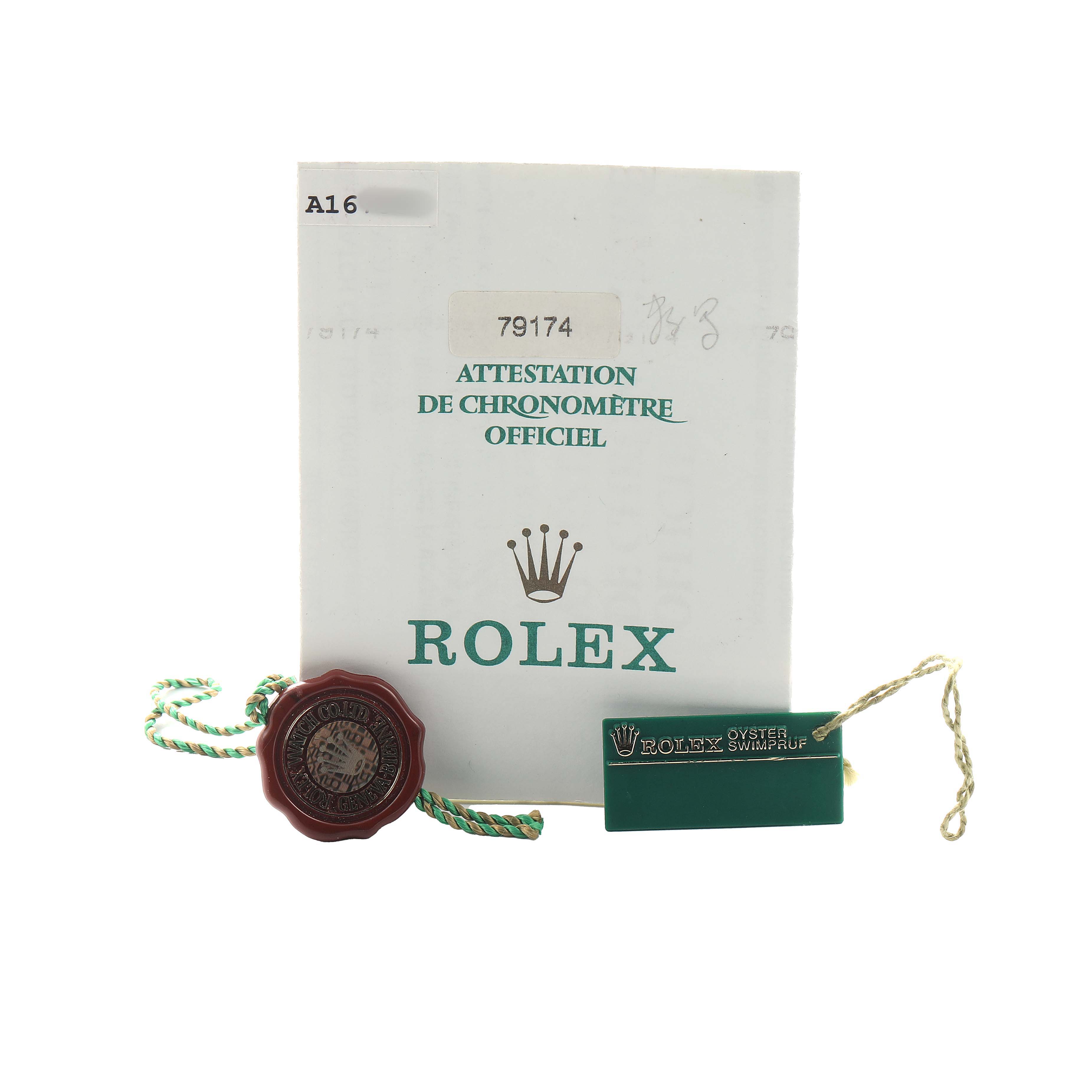 The image shows Rolex Datejust 79174 Women's Stainless Steel Pink Dial accessories including a certification booklet, a seal, and a tag.
