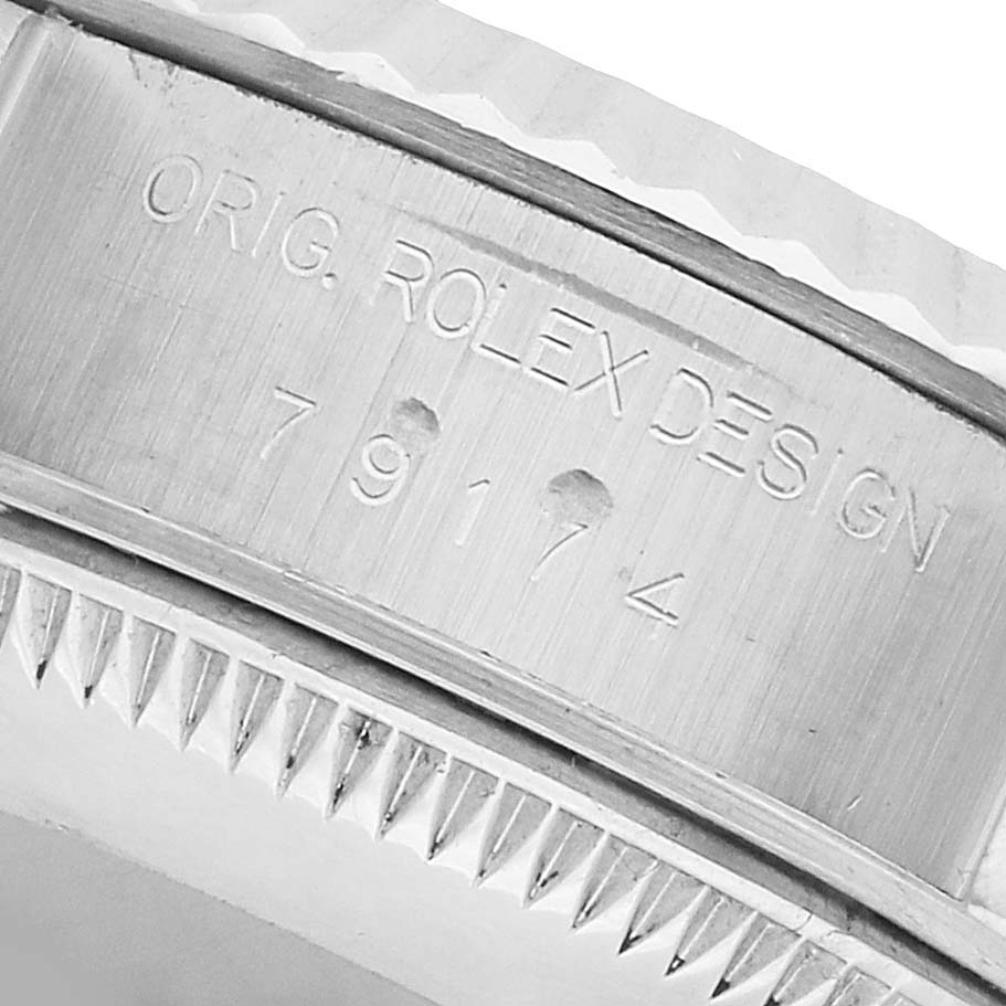 The image shows a close-up of the Rolex Datejust 79174 Women's Stainless Steel Pink Dial watch case side with etched model and design details.