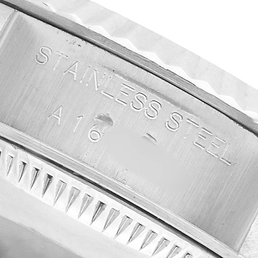 The image shows the side engraving on a stainless steel Datejust by Rolex, highlighting its material and texture.