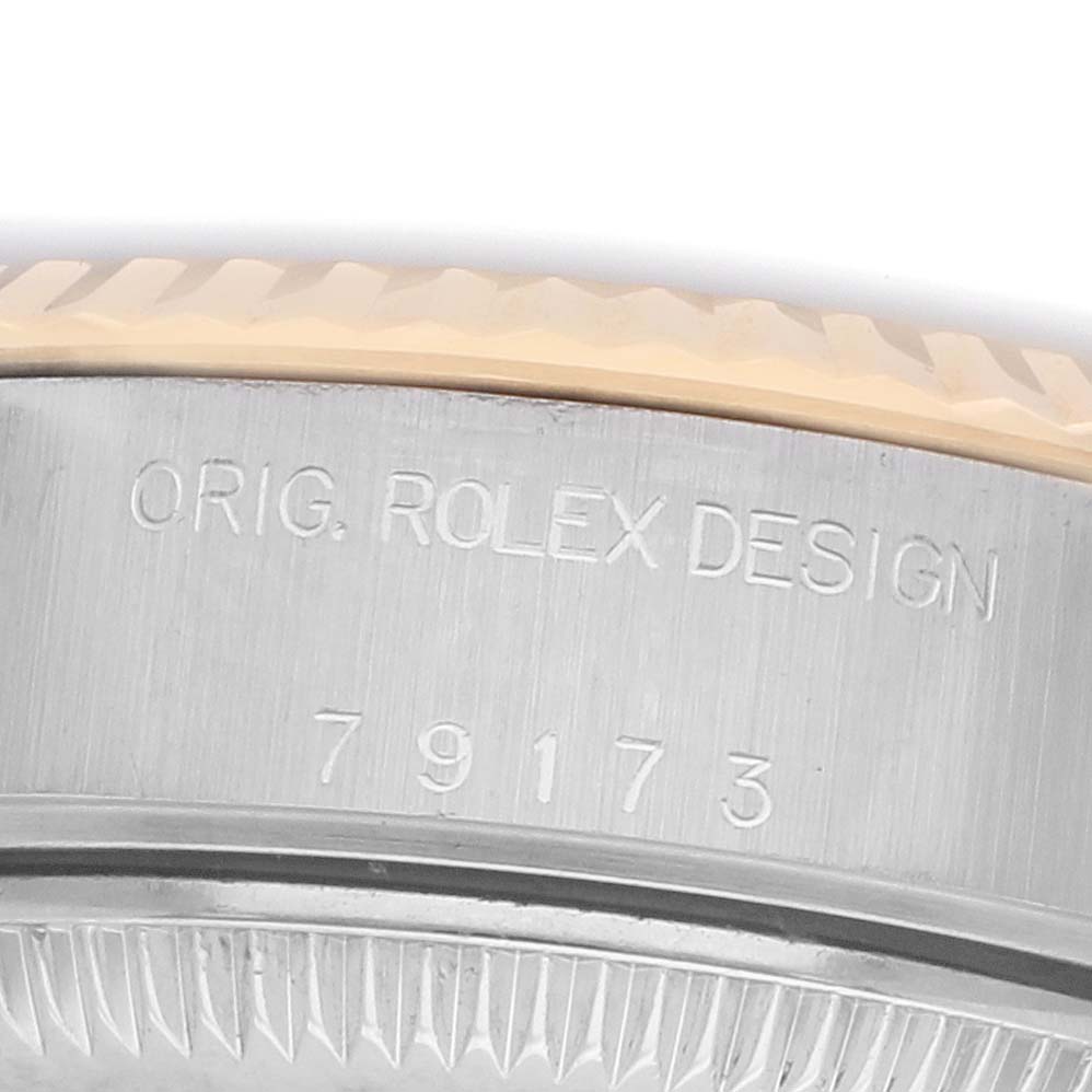 The image shows a close-up of the side of a Rolex Datejust 79173 Women's Steel and Gold (two tone) Silver Dial watch, highlighting the model number and "ORIG. ROLEX DESIGN" engraving.