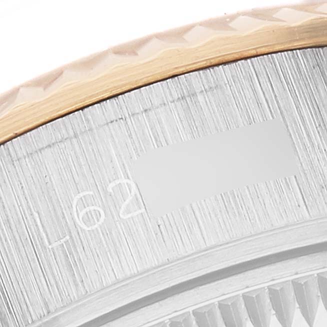 This image shows a close-up of the bezel and rehaut engraved with some text of a Rolex Datejust 69173 Women's Steel and Gold (two tone) Champagne Dial 69173 Women's Steel and Gold (two tone) Champagne Dial watch.