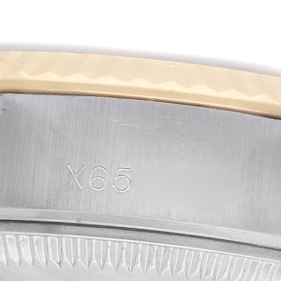 The image shows a partial close-up of the case back edge and serial number engraving on a Rolex Datejust 69173 Women's Steel and Gold (two tone) Silver Dial watch.
