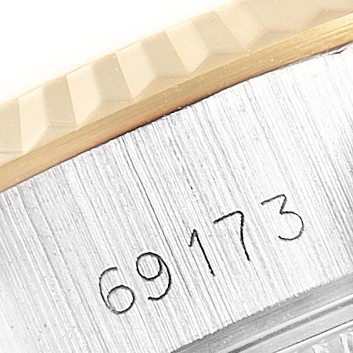 This close-up shows the model number and part of the fluted bezel of a Rolex Datejust 69173 Women's Steel and Gold (two tone) White Dial 69173 Women's Steel and Gold (two tone) White Dial watch.