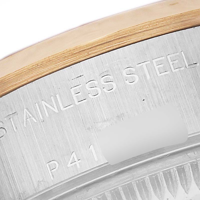This image shows a close-up of the edge and engravings on the case back of a Rolex Datejust 79163 Women
s Steel and Gold (two tone) White Dial 79163 Women
s Steel and Gold (two tone) White Dial watch.