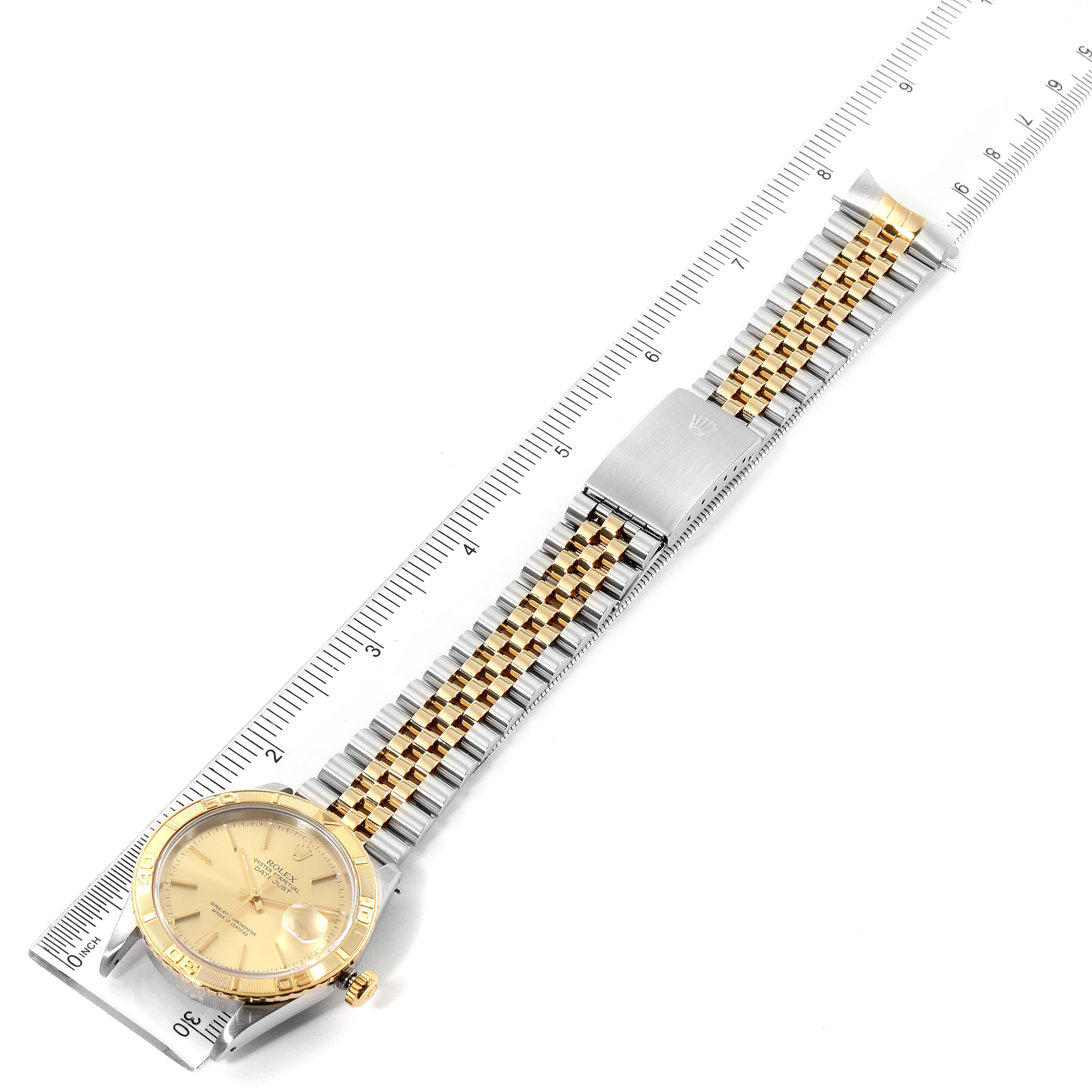 The image shows a Rolex Turn-o-Graph 16263 Men
s Steel and Gold (two tone) Champagne Dial 16263 Men
s Steel and Gold (two tone) Champagne Dial watch laid flat with a full view of its two-tone bracelet and face, alongside a ruler for size reference.