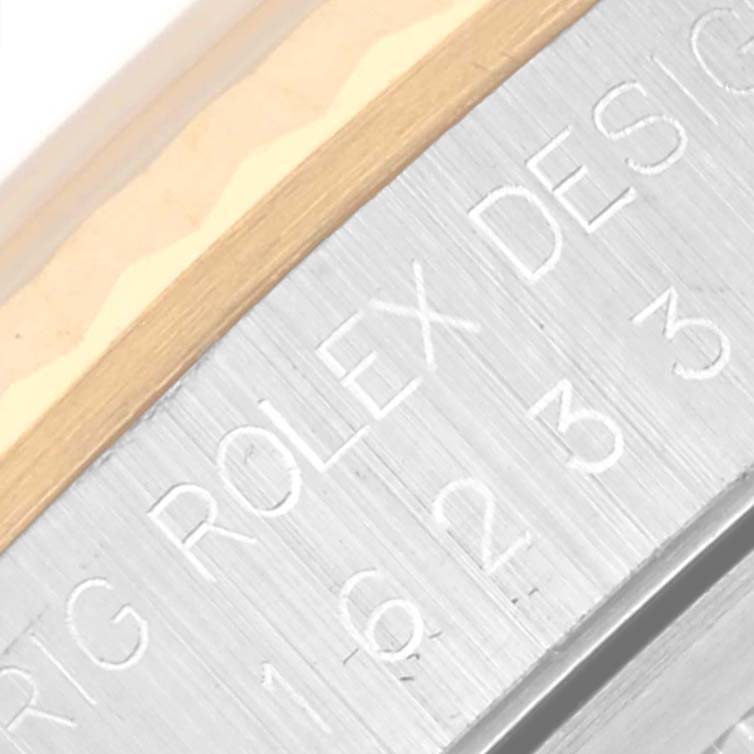 The image shows an angled close-up of the Rolex Datejust 16233 Men's Steel and Gold (two tone) White Dial 16233 Men's Steel and Gold (two tone) White Dial model's side, highlighting the engraved branding and part of the bezel.