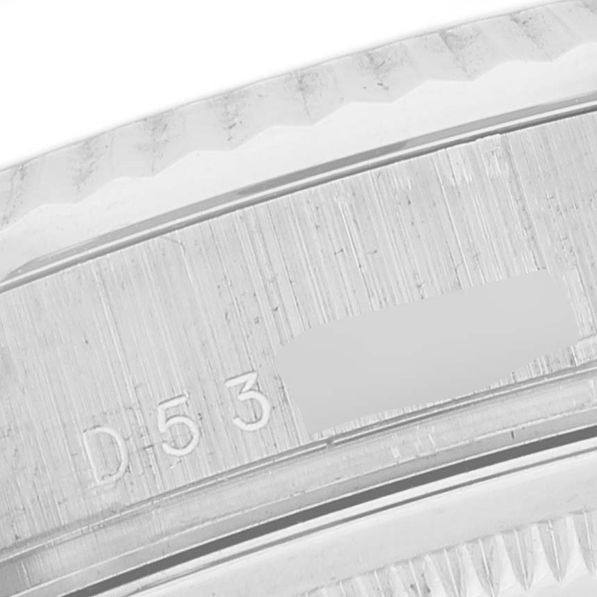 This close-up image shows the engraved serial number on the bezel of a Rolex President 118239 Men's White Gold Pink Dial 118239 Men's White Gold Pink Dial model watch.