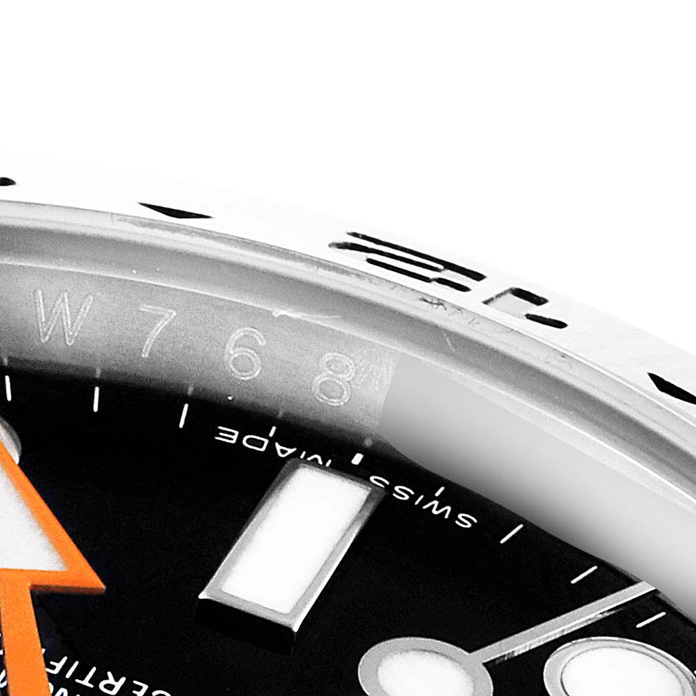 Close-up angle of the dial and bezel of a Rolex Explorer 216570 Men
s Stainless Steel Black Dial 216570 Men
s Stainless Steel Black Dial, highlighting the orange arrow hand and part of the chapter ring.