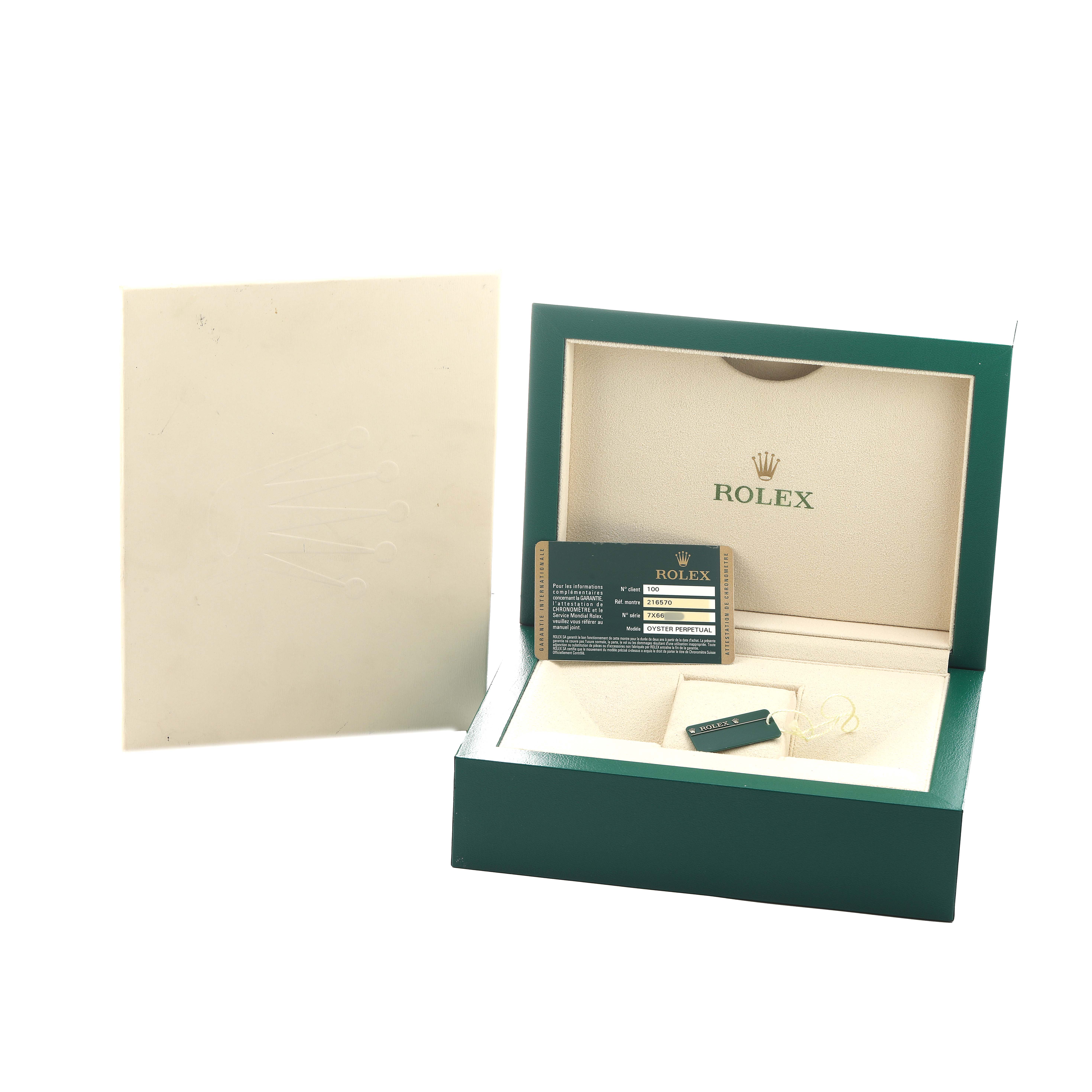 The image shows an open Rolex Explorer 216570 Men's Stainless Steel White Dial watch box with a warranty card and book, featuring the brand logo inside.