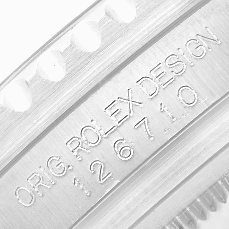 The image shows a close-up of the inner bezel with engravings on the Rolex GMT-Master 126710 Men's Stainless Steel Black Dial watch.