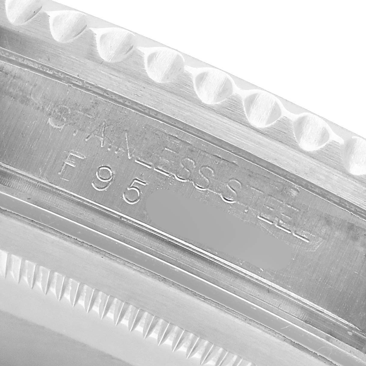 The image shows a close-up of the milled edge and inner bezel with engravings of the Rolex GMT-Master 16710 Men's Stainless Steel Black Dial model.