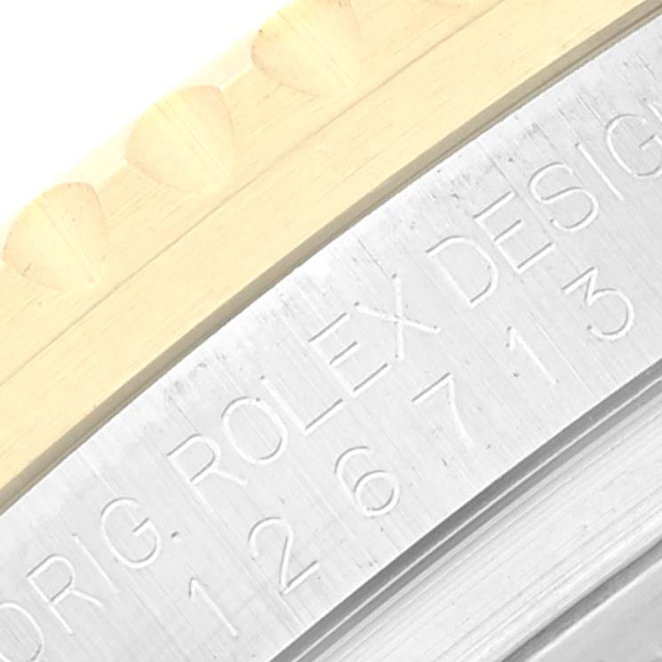 The image shows a close-up view of the case side and engraved details of a Rolex GMT-Master 126713 Men's Steel and Gold (two tone) Black Dial 126713 Men's Steel and Gold (two tone) Black Dial watch.