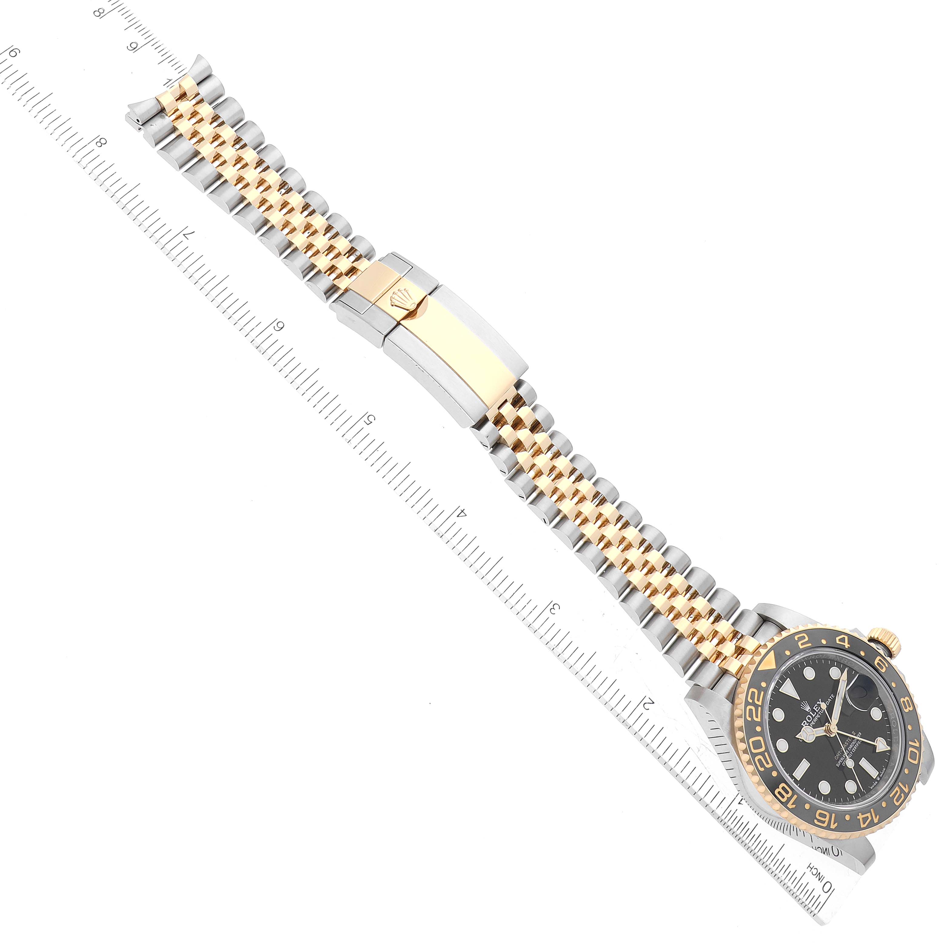 The image shows a Rolex GMT-Master 126713 Men's Steel and Gold (two tone) Black Dial 126713 Men's Steel and Gold (two tone) Black Dial watch laying flat, displaying the face, bracelet, and clasp with a ruler adjacent for size reference.