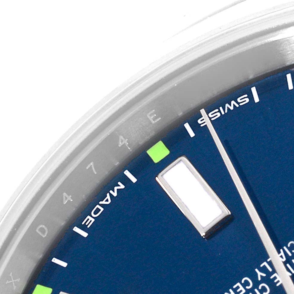 This image shows a close-up of the dial and part of the bezel of a Rolex Oyster Perpetual 114300 Men
s Stainless Steel Blue Dial 114300 Men
s Stainless Steel Blue Dial watch.