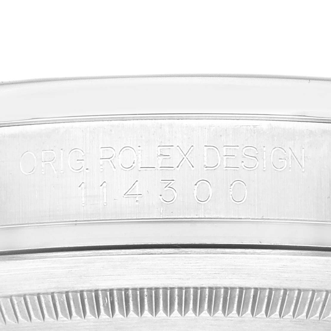 This close-up image shows the case side and the reference number of the Rolex Oyster Perpetual 114300 Men
s Stainless Steel Blue Dial 114300 Men
s Stainless Steel Blue Dial model.