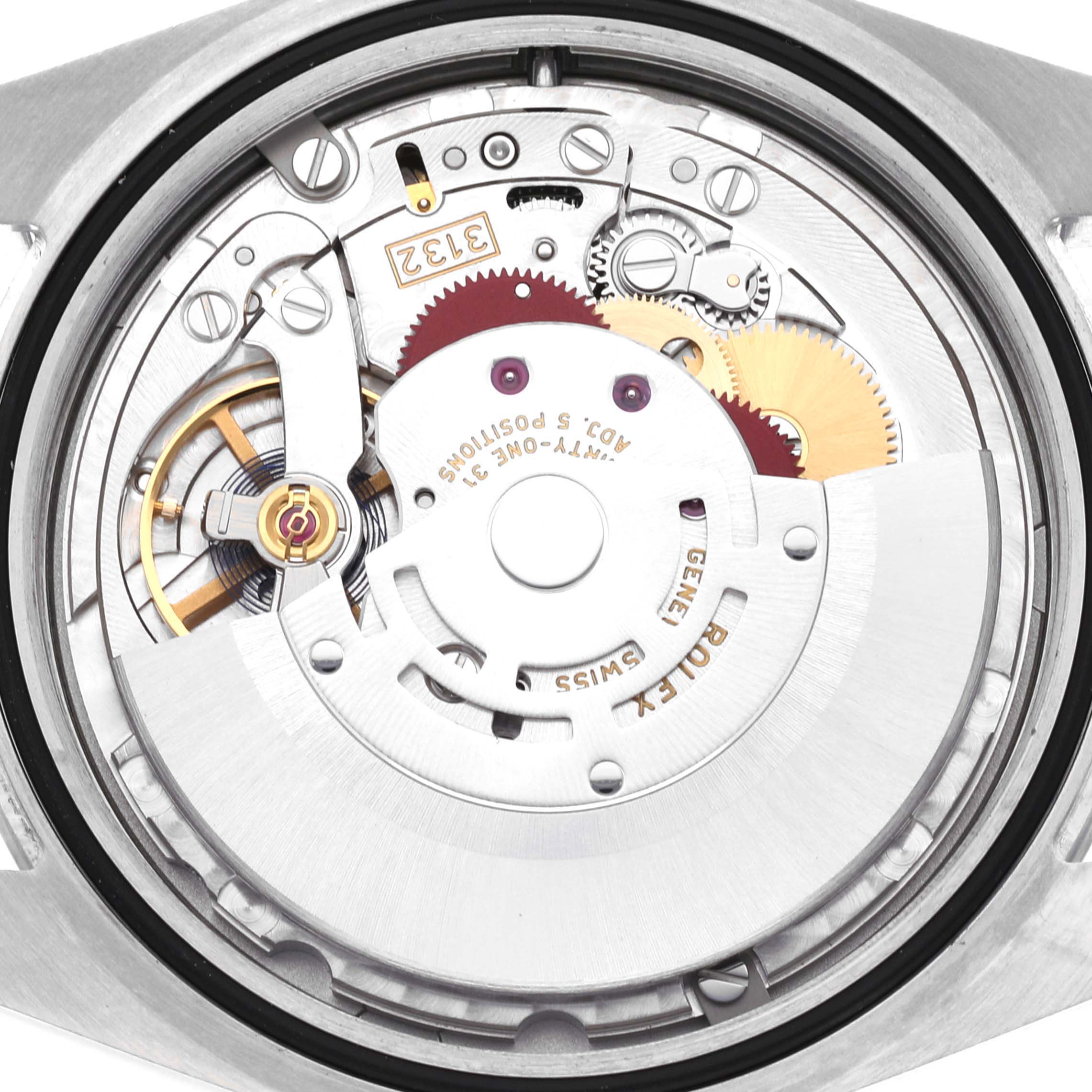 The image shows the back view revealing the internal movement mechanisms of the Rolex Oyster Perpetual 114300 Men
s Stainless Steel Blue Dial 114300 Men
s Stainless Steel Blue Dial watch.