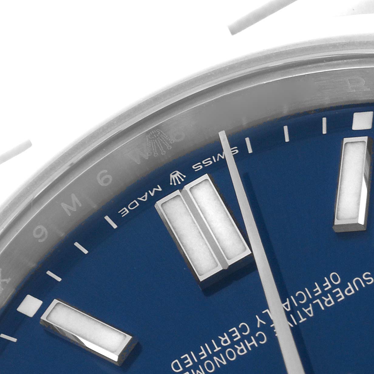 The image shows a close-up of the blue dial and markers of a Rolex Oyster Perpetual 124300 Men's Stainless Steel Blue Dial 124300 Men's Stainless Steel Blue Dial watch at an angled perspective.