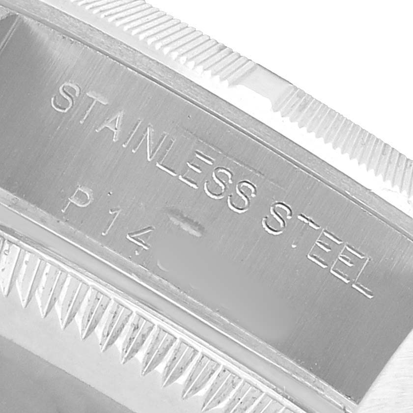 The image shows a close-up of the side of a Rolex Oyster Perpetual 76030 Women's Stainless Steel White Dial watch case with "STAINLESS STEEL" engraving.