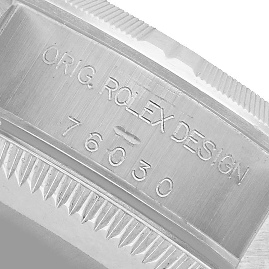 The image shows the engraved side of the bezel of a Rolex Oyster Perpetual 76030 Women's Stainless Steel White Dial, highlighting its model number.