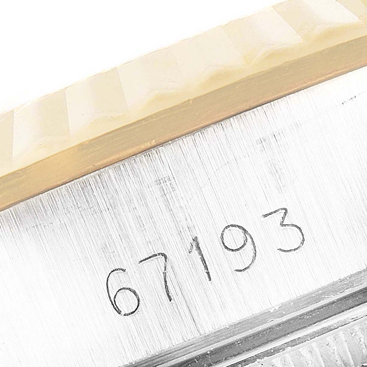 The image shows a close-up of the side engraving on the case of a Rolex Oyster Perpetual 67193 Women
s Steel and Gold (two tone) Black Dial 67193 Women
s Steel and Gold (two tone) Black Dial model 67193.