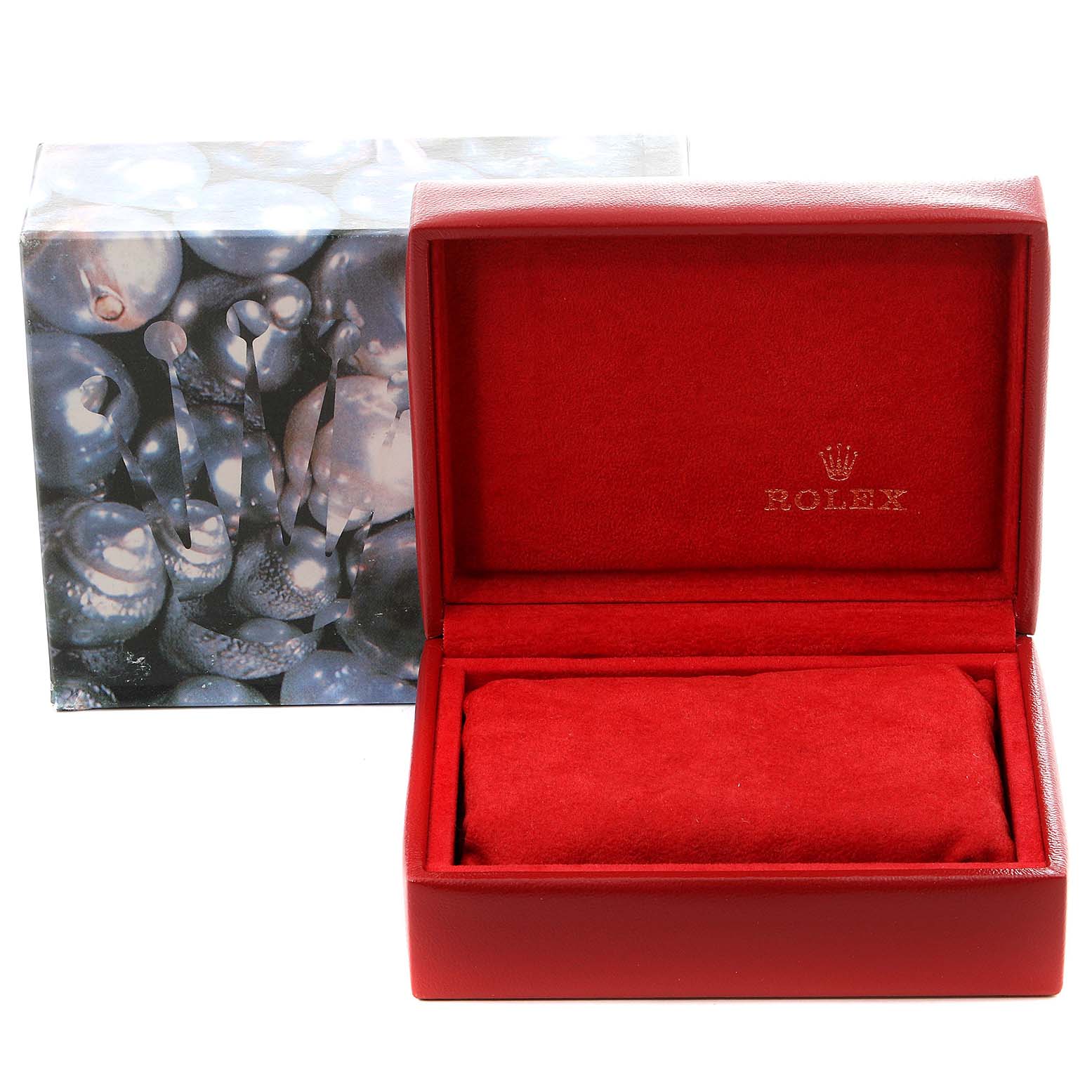 This image shows a red Rolex watch box with the lid open and a decorative outer box behind it.