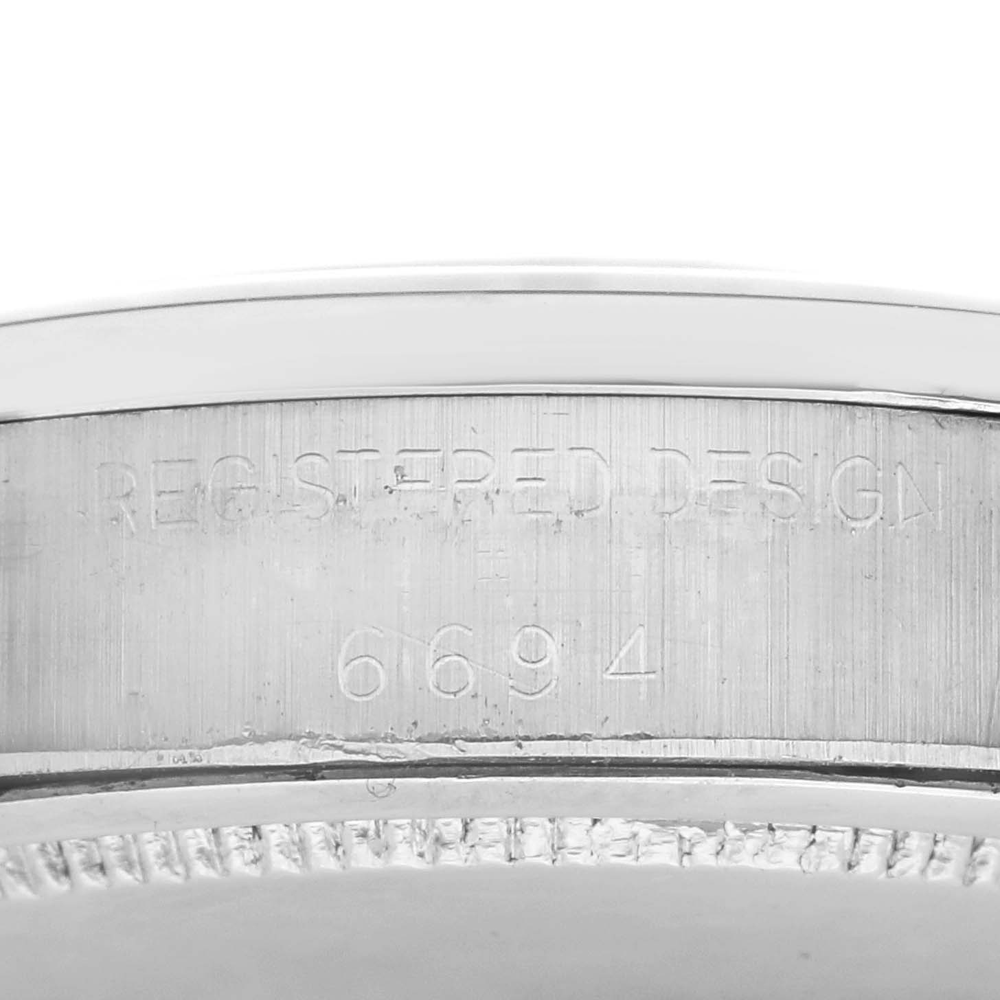 The image shows the engraved side of the Rolex Vintage Collection 6694 Men's Stainless Steel Pink Dial 6694 Men's Stainless Steel Pink Dial model featuring the serial number.