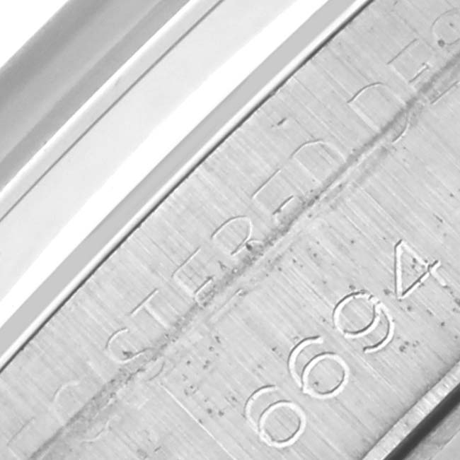 The image shows a close-up of the engraved case side on a Vintage Collection by Rolex.