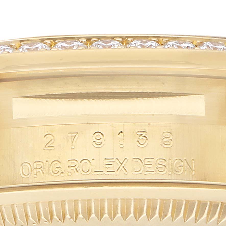 The image shows a close-up of the Rolex President 279138 Women's Yellow Gold Champagne Dial model's engraved inner side and diamond-set bezel.