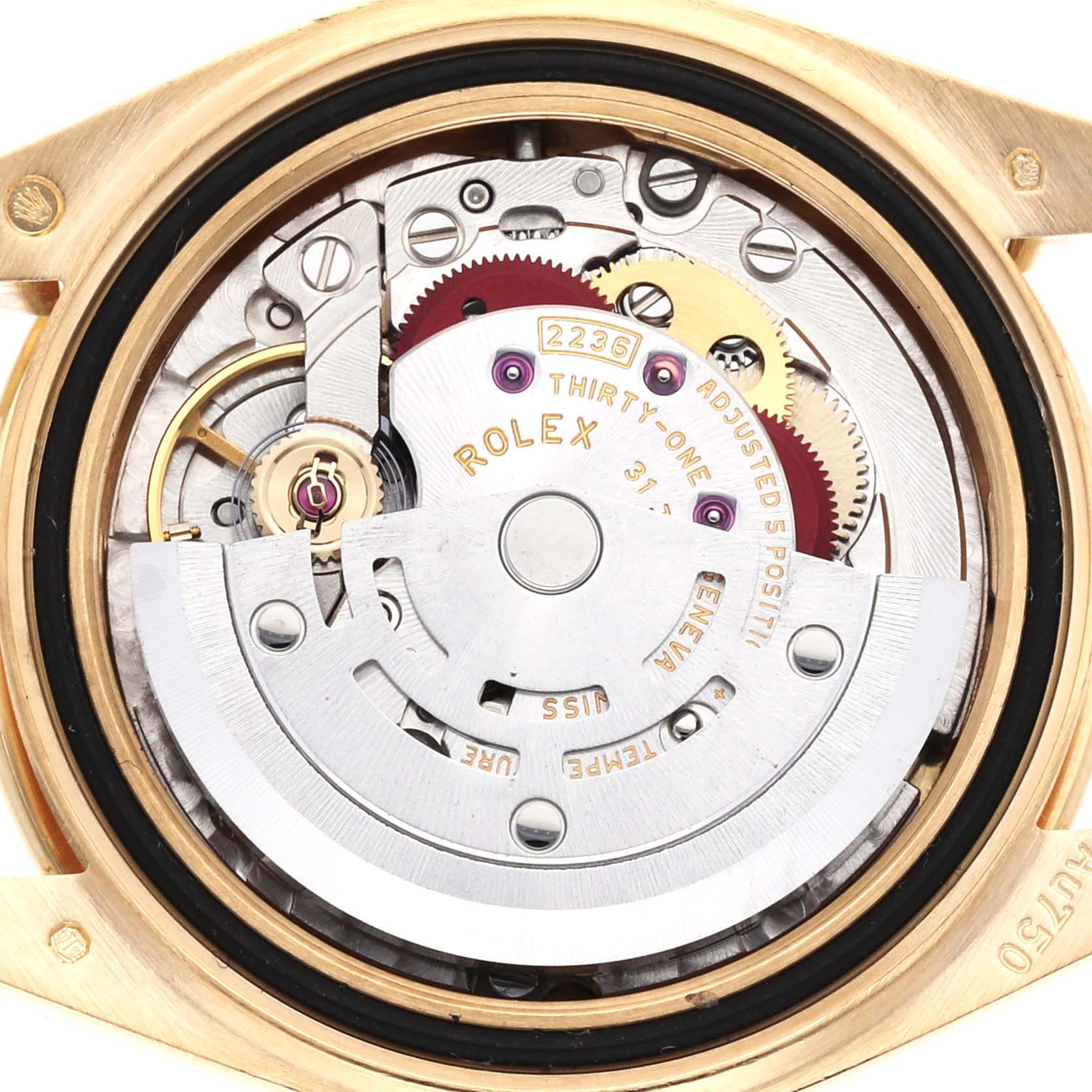 The image shows the movement of a Rolex President 279138 Women's Yellow Gold Champagne Dial watch from a top-down angle, highlighting gears and components.