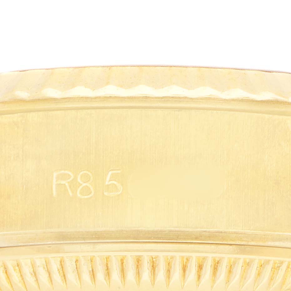 The image shows a close-up of the side of a Rolex President 69178 Women's Yellow Gold Champagne Dial model, highlighting the engraved number and part of the fluted bezel.