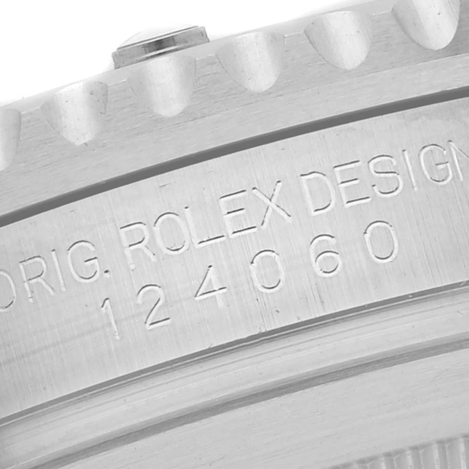 The image shows a close-up of the engraved side of a Rolex Submariner 124060 Men
s Stainless Steel Black Dial 124060 Men
s Stainless Steel Black Dial watch, displaying its model number 124060.