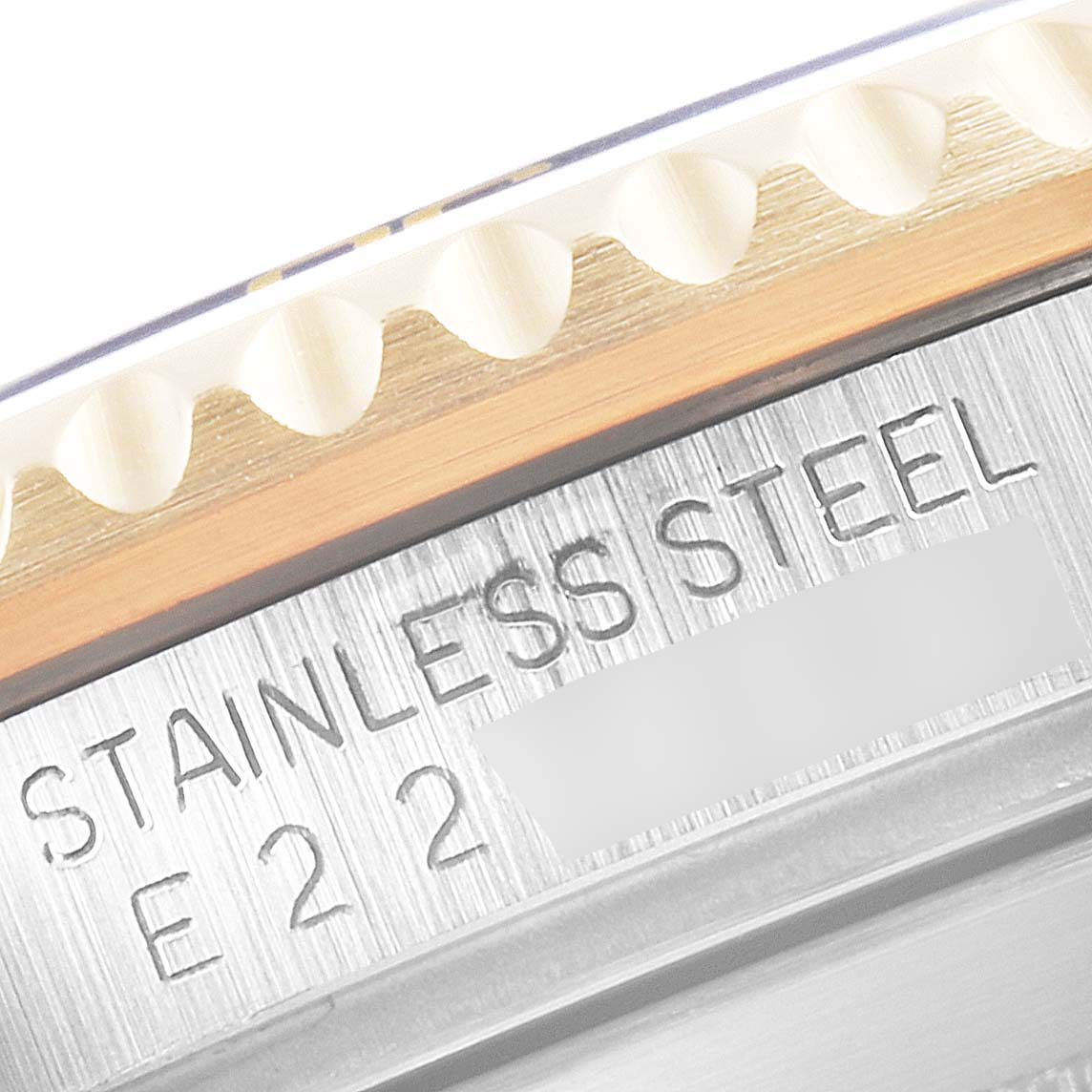 The image shows a close-up of the case side and bezel teeth of a stainless steel Rolex Submariner 16613 Men's Steel and Gold (two tone) Blue Dial 16613 Men's Steel and Gold (two tone) Blue Dial watch with the engraving visible.