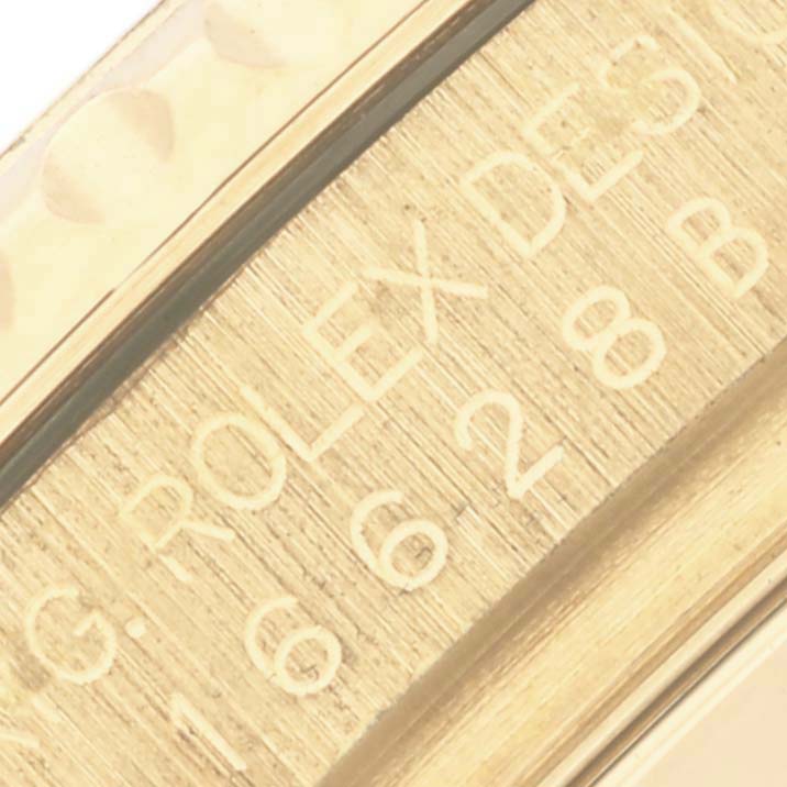 The image shows a close-up of the engraved edge of a Rolex Yacht-Master 16628 Men's Yellow Gold White Dial 16628 Men's Yellow Gold White Dial watch, highlighting the model number.