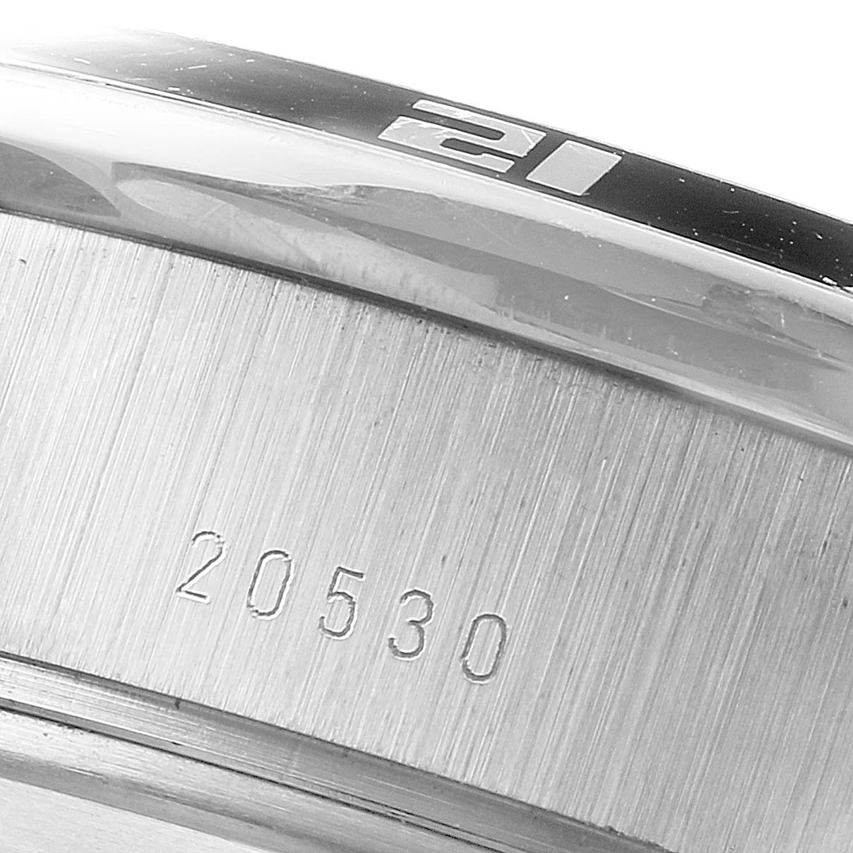 The image shows a close-up of the case side and bezel of a Tudor Grantour 20530N Men
s Stainless Steel Silver Dial 20530N Men
s Stainless Steel Silver Dial watch, emphasizing the serial number and part of the bezel
s number "21".